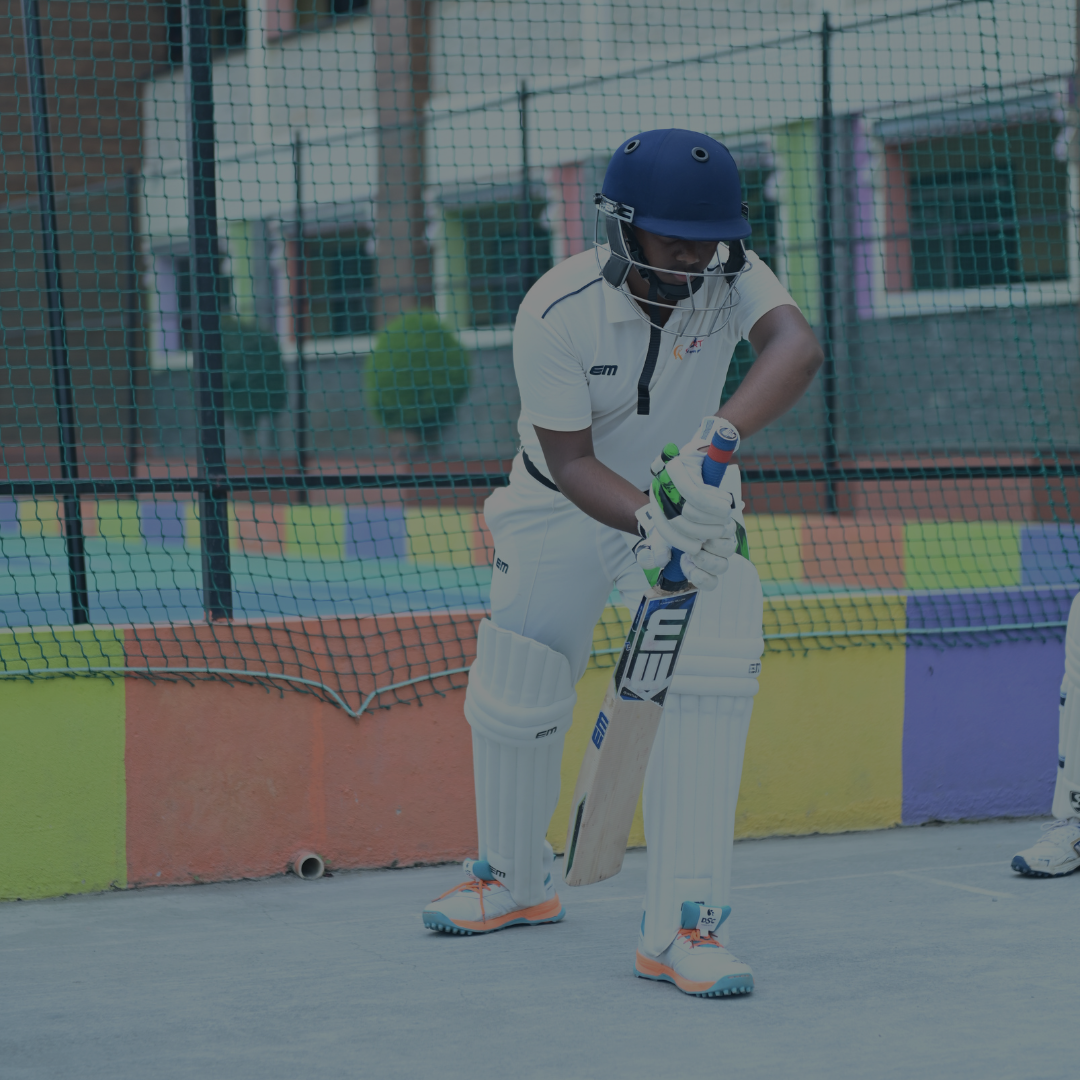 Student batting at cricket practice